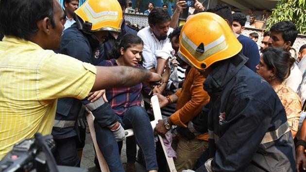 Firefighters with a woman rescued from a commercial building in which fire broke out , Andheri in Mumbai, on Monday, October 14, 2019. (HT PHOTO) Firefighters with a woman rescued from a commercial building in which fire broke out , Andheri in Mumbai, on Monday, October 14, 2019. (HT PHOTO)