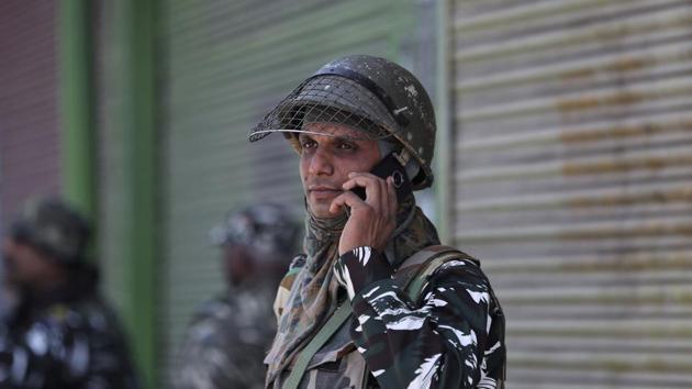 An Indian paramilitary soldier talks on his cellphone as he guards a closed market in Srinagar. J&K has been in the grip of restrictions since August 5. The central government’s decision has triggered intense debate in the country and even beyond its borders, with opposition parties criticising the curbs and the detention of the state’s political leaders, including former chief ministers. The government says it has taken all necessary steps to maintain security in the militancy-hit state. (Mukhtar Khan / AP)