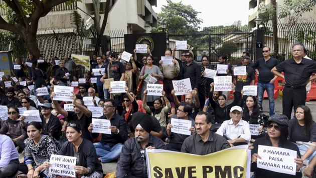 Mumbai: Depositors of Punjab and Maharashtra Cooperative (PMC) bank display placards during a protest over the bank's crisis, outside the Reserve Bank of India building, in Mumbai.(PTI)