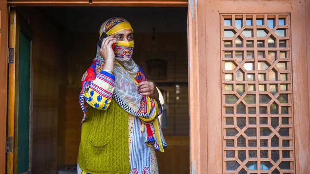 A woman talks to her son. Locals appeared relieved after the easing of the communications embargo, dialling their relatives, and wishing each other “Eid Mubarak” — the festival fell on August 12, about a week after the ban kicked in. (S. Irfan / PTI)