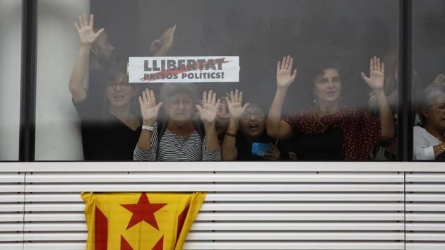 Protesters stand behind a banner reading in Catalan, “Freedom for Political Prisoners” at El Prat airport in Barcelona. Spain’s Supreme Court on Monday jailed nine Catalan separatist leaders for between nine and 13 years for their role in a failed independence bid, a decision that triggered mass protests in the region and left the future course of the dispute uncertain. (Emilio Morenatti / AP)