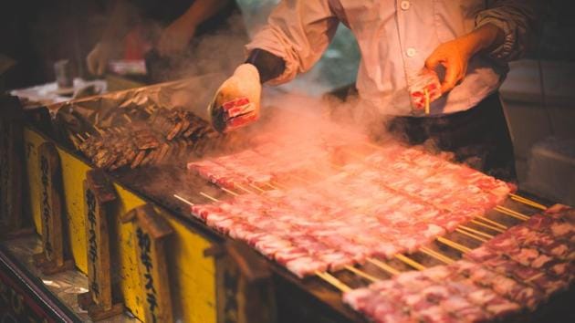 Man grilling meat. (Representational Image)(Unsplash)