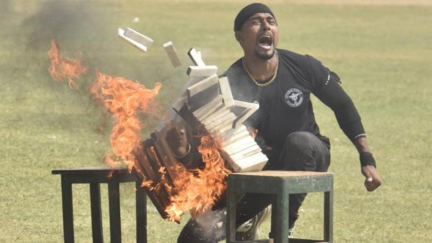 A NSG Commando performs a drill during the 35th NSG Raising Day at NSG Manesar campus, in Gurugram, on Tuesday, October 15. The National Security Guard (NSG), popularly known as the Black Cats is an elite striking force in the country, established in 1984. It has six operational centres, which have full capability to handle all situations like a terrorist attack, hijacking, and hostage captivity among others. It also handles VIP security. (Sanjeev Verma/HT Photo)