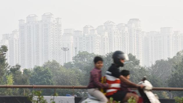 A motorist passes high rise buildings shrouded in heavy smog at Moti Nagar in New Delhi on Wednesday. System for Air Quality and Weather Forecasting and Research (SAFAR) — the ministry of earth sciences’ weather and air quality monitoring system —showed that only 5% of the PM 2.5 levels recorded in Delhi came from stubble burning emissions on Wednesday. (Sanchit Khanna / HT Photo)