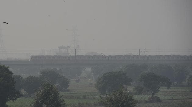A metro train moves as smog engulfs the city skyline, at Mayur Vihar in Delhi on October 17. Fires from stubble burning observed so far through satellite images are at the lowest level since 2013, said Hiren Jethva, research scientist, Universities Space Research Association (USRA) at NASA’s Goddard Space Flight Centre. (Mohd Zakir / HT Photo)