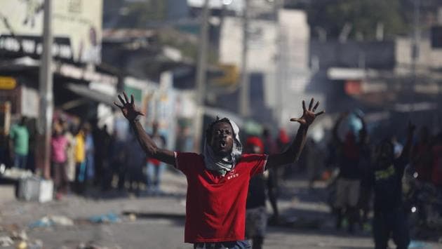 An anti-government protester shouts that Haitian President Jovenel Moise must step down, in Port-au-Prince. The country has entered its enters its fifth week of protests that have paralysed the economy. The protests are fuelled by anger over corruption, inflation that has reached 20% and dwindling of basic supplies, including gasoline. (Rebecca Blackwell / AP)