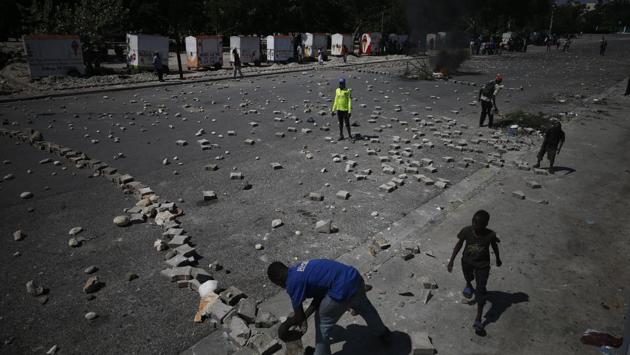 Protesters use paving stones and rocks to barricade a road near the presidential palace. A new budget hasn’t been approved for two years, prompting organizations like the International Monetary Fund and others to withhold aid. On Tuesday the UN’s Mission for Justice Support in Haiti ended its mandate, marking the first time since 2004 that there was no UN peacekeeping operation in Haiti. (Rebecca Blackwell / AP)