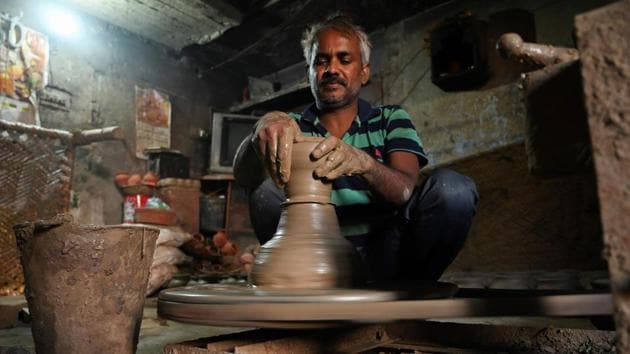 “I am teaching them the same way I learnt from my father, he learnt from his father and so on,” Kumar said as he sat at a wheel with many fresh clay pots behind him. “People come to us from across India and not just Delhi,” he added. (Money Sharma / AFP)