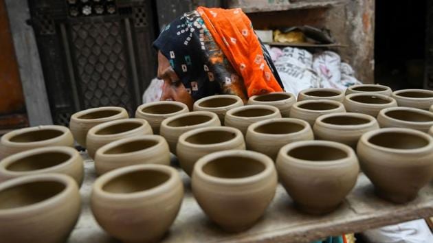 In many households, entire families are involved in the steps to make the finished products. Jagmohan, who only goes by one name, shares the process of making ornate clay objects with his brothers, their wives, his parents and their children. The 48-year-old sits at the wheel churning different types of pots, lamps and flower vases throughout the day, particularly in weeks leading up to the famed Festival of Lights. (Money Sharma / AFP)