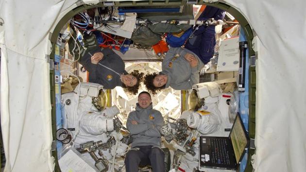 Andrew Morgan with Christina Koch and Jessica Meir at the International Space Station on October 18. Men have floated out the hatch on all 420 spacewalks conducted over the past half-century. But that changed on Friday with spacewalk No. 421. (NASA / AP)