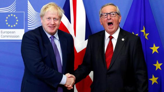 European Commission President Jean-Claude Juncker and Britain’s Prime Minister Boris Johnson shake hands during a news conference after agreeing on the Brexit deal, at the sidelines of the European Union leaders summit, in Brussels, Belgium. (Francois Lenoir / REUTERS)