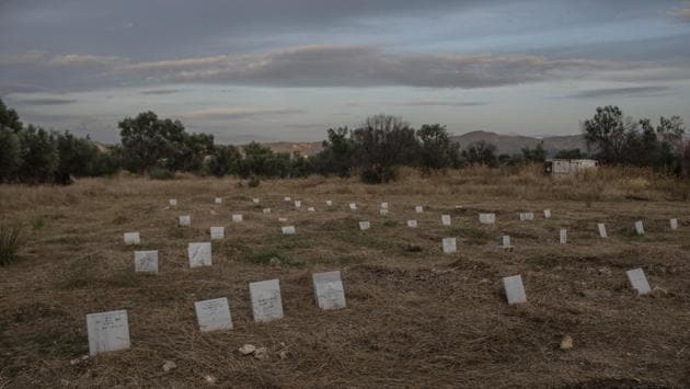 Tombstones marking the graves of migrants and refugees who drowned at sea while crossing from nearby Turkey are seen at a cemetery near the village of Kato Tritos. The surge started before Turkey’s military offensive against Kurdish fighters in Syria. Since the offensive began last week, Turkish President Recep Tayyip Erdogan has sought to quell European criticism by warning that he could “open the gates” and send more than 3 million Syrian refugees to Europe. (Petros Giannakouris / AP)