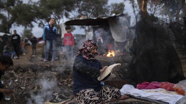 Pargoul Rahmani, 57, makes bread at a makeshift bakery in the overcrowded Moria refugee and migrant camp. Human rights group Amnesty International has described Moria as “overcrowded and unsafe” and urged other EU countries to help Greece settle asylum-seekers. Greece’s new conservative government says it also plans to detain migrants without the right to request asylum and wants to resume deportations back to Turkey under terms detailed in the 2016 EU-Turkey deal. (Petros Giannakouris / AP)