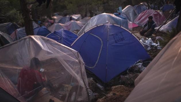 A Syrian refugee prays next to tents at the perimeter of the overcrowded refugee and migrant camp at Vathy on the island of Samos. It said more than 11,500 attempts to enter the EU via the eastern Mediterranean Sea were recorded in September, up 16% from the month of August. It detected almost 50,600 border crossing attempts in the eastern Mediterranean in the first nine months of this year, up 22% from last year. (Petros Giannakouris / AP)