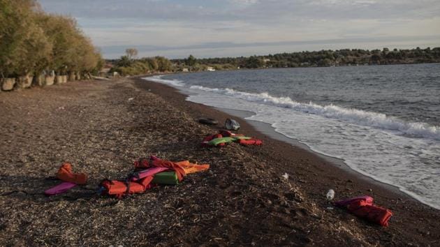 Life vests are seen on a beach at the seaside village of Tsonia, Lesbos island, Greece after the arrival of refugees and migrants on a rubber boat from Turkey. Greece’s eastern islands are struggling to cope with a surge in arrivals of migrants and asylum-seekers that has undermined efforts to ease severe overcrowding at refugee camps. (Petros Giannakouris / AP)