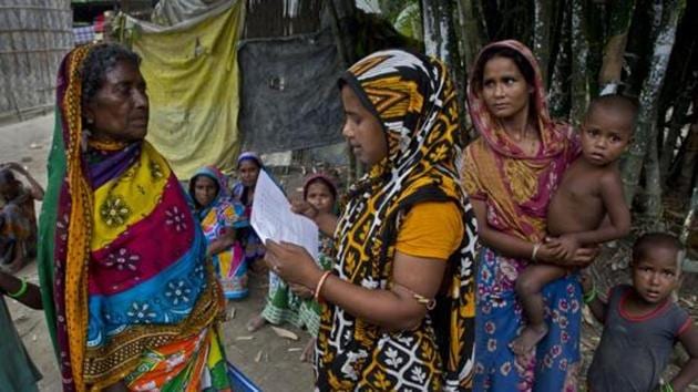 A woman checks for names in the final list of the National Register of Citizens (NRC) on a printed sheet of paper in Pabhokati village in Morigaon district, Assam.(AP File)