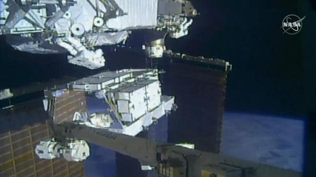NASA astronauts Christina Koch and Andrew Morgan work outside the International Space Station on October 06, 2019. The astronauts kicked off the first of five spacewalks to replace old batteries at the International Space Station. Though the battery charger failed after Koch and Morgan installed new batteries. NASA then put the remaining battery replacements on hold to fix the problem and moved up the women’s planned spacewalk by three days. (NASA / AP)