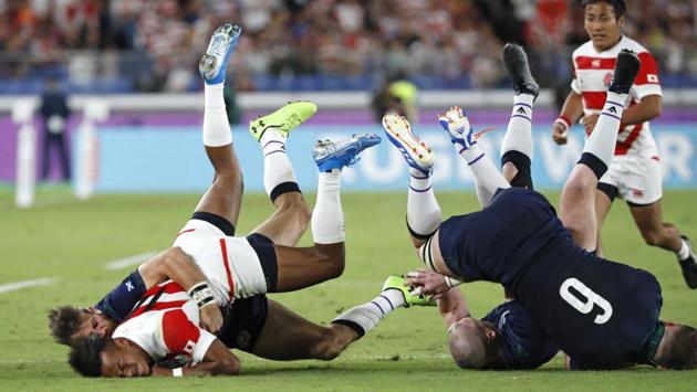 Japan’s Kotaro Matsushima, (C, left) is tackled by Scotland’s defense during the Rugby World Cup Pool A game at International Stadium between Japan and Scotland in Yokohama, Japan. (Eugene Hoshiko / AP)