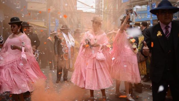 Dancers from a preste celebration shoot confetti in Eloy Salmon Street in Zona Gran Poder, La Paz, Bolivia. Bolivian leader Evo Morales came to power in 2006 with a pledge to champion marginalized indigenous groups including his own important Andean tribe the Aymara, which helped carry him to the presidency. (Manuel Seoane / REUTERS)