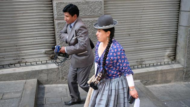 Aymara radio presenter and Youtuber Yolanda Mamami, 34, also known as ‘Big Mouth Chola’, a reference to the indigenous women often clad in iconic wide dresses and bowler hats who have gained prominence under Morales, walks down the main square to interview congress members. “Indigenous ideologies haven’t really been translated to politics... It’s like a fashion show of folklore, as if the indigenous were just clothing,” she said. (Manuel Seoane / REUTERS)