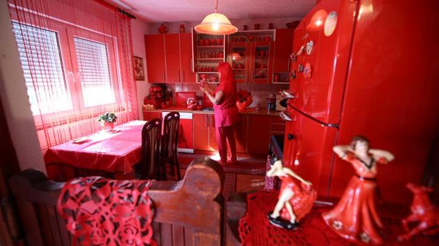 Zorica Rebernik, obsessed with the red color, stands in the kitchen inside her house in the village of Breze near Tuzla, Bosnia and Herzegovina. (Dado Ruvic / REUTERS)