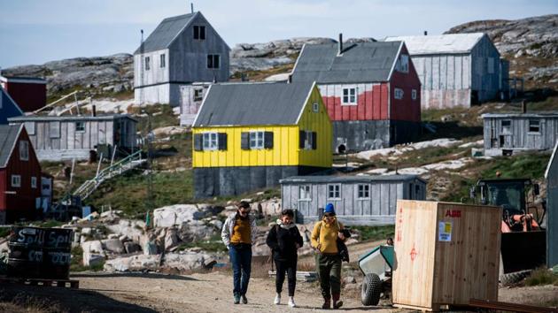 Many of the 85,000 tourists who visit each year head to the west coast, but eastern Greenland, with its glaciers, wilderness and wildlife starring whales and polar bears, is also drawing visitors. Sarah Bovet, a Swiss artist, was on an artistic residency in Greenland when she visited Kulusuk and its 250 souls. Although she had imagined a small village before arriving, its stunning views and bright colours still came as a surprise. (Jonathan Nackstrand / AFP)