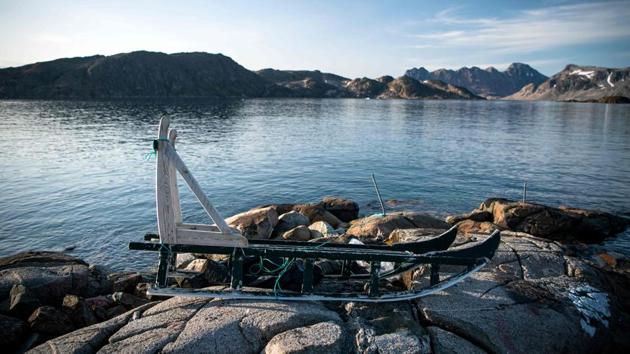 A sled is pictured in Kulusuk, a settlement in the Sermersooq municipality located on the island of the same name on the southeastern shore of Greenland. Kayaking past blue-white icebergs drifting along near a pristine harbour, wandering around colourful houses or trekking in the snow-capped wilderness--July and August are high season for tourists in eastern Greenland. (Jonathan Nackstrand / AFP)