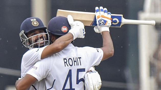 Ranchi: Indian cricketer Rohit Sharma celebrates after scoring 100 runs with teammate Ajinkya Rahane.(PTI)