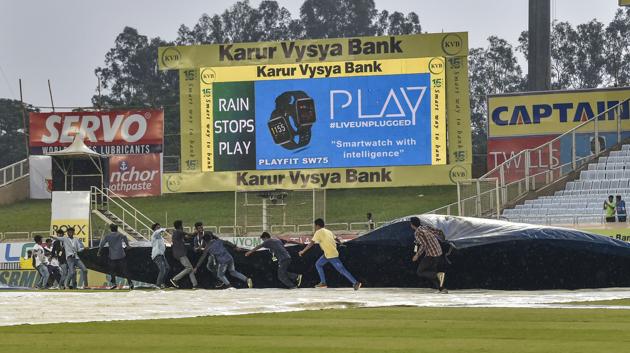 Ranchi: Workers cover the ground as rain stops play during the first day of the 3rd Test match between India and South Africa at JSCA Stadium in Ranchi. (PTI)