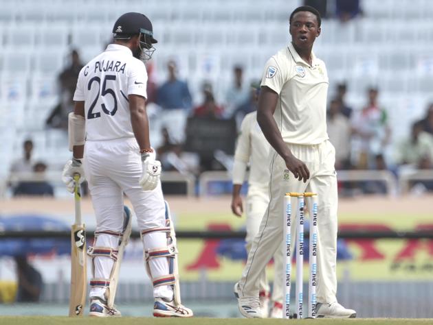 South Africa's Kagiso Rabada, right, reacts after asking for a successful review for the wicket of India's Cheteshwar Pujara, left, during the third and last cricket test match between India and South Africa in Ranchi. (AP)