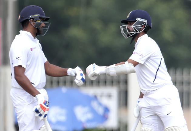India's Rohit Sharma, left, and Ajinkya Rahane touch their gloves during first day of the third and last cricket test match between India and South Africa in Ranchi. (AP)