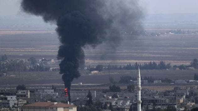 Smoke billows from a fire in Ras al-Ayn as fighting broke out in the Syrian border town which has been a flashpoint in the fight between Turkey and Kurds.(AP photo) Smoke billows from a fire in Ras al-Ayn as fighting broke out in the Syrian border town which has been a flashpoint in the fight between Turkey and Kurds.(AP photo)