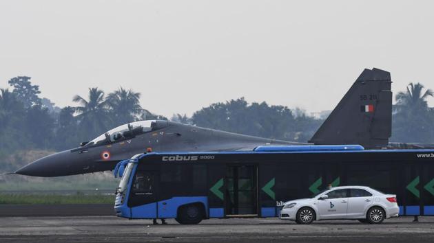 An Indian Air Force (IAF) Sukhoi Su-30 fighter jet is pictured behind a bus and a car as it takes part in exercises at Netaji Subhas Chandra Bose International Airport in Kolkata. The Indian Air Force’s Eastern Air Command is holding fighter jet training flights on six airfields including Dimapur, Imphal, Guwahati, Kolkata, Pasighat and Andal, to familiarize IAF crews with flying on busy commercial airfields in the event of emergency requirements. (Dibyangshu Sarkar / AFP)
