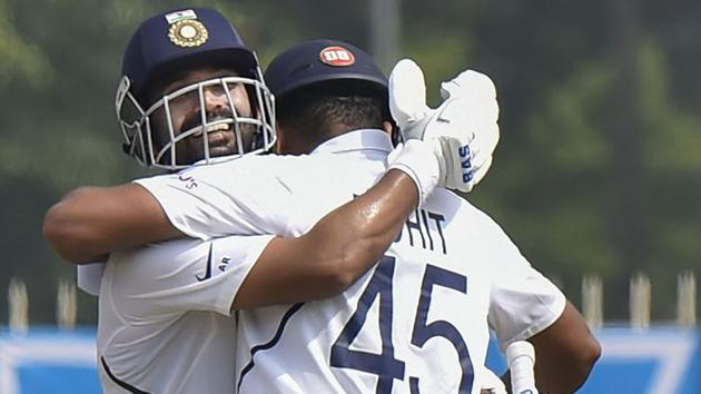 India's Ajinkya Rahane celebrates his century with partner Rohit Sharma.(PTI)