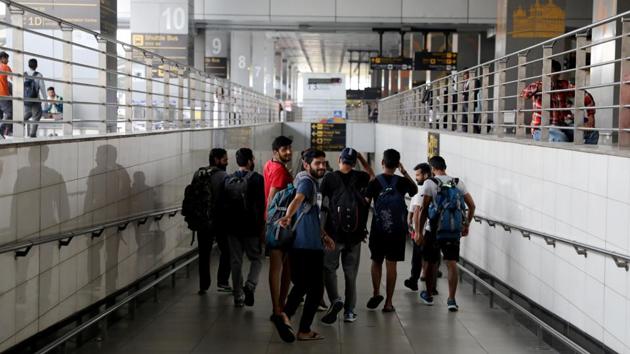 Indian men deported from Mexico for illegally entering the country, walk away to catch local transport to get back to their homes after landing in New Delhi. (Anushree Fadnavis / REUTERS)