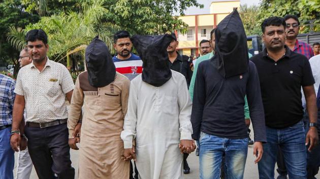Gujarat Anti-terrorist squad (ATS) officers produce and hand over three suspect related to the murder of Hindu Samaj Party founder-leader Kamlesh Tiwari to UP Police, in Ahmedabad.(PTI)