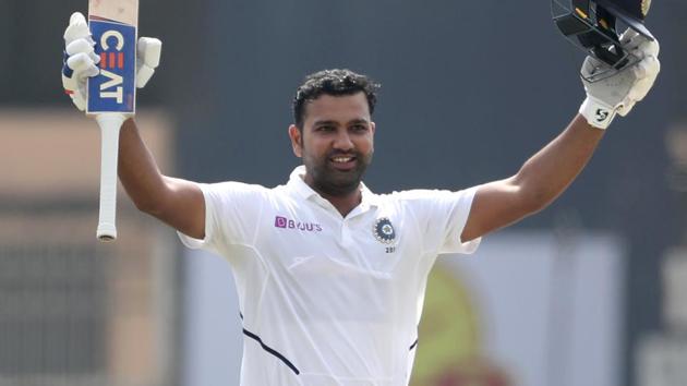 India's Rohit Sharma raises his bat and helmet to celebrate scoring double century.(AP)