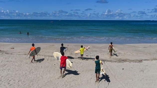 “We surf for at least four to six hours a day,” said American coach Robert Brickell, a 26-year-old originally from New York. “My hope is that we can show everybody that people from Myanmar, we know how to surf, we know how to respect the ocean,” he said. “And of course our hope is to win some meets.” (Ye Aung Thu / AFP)