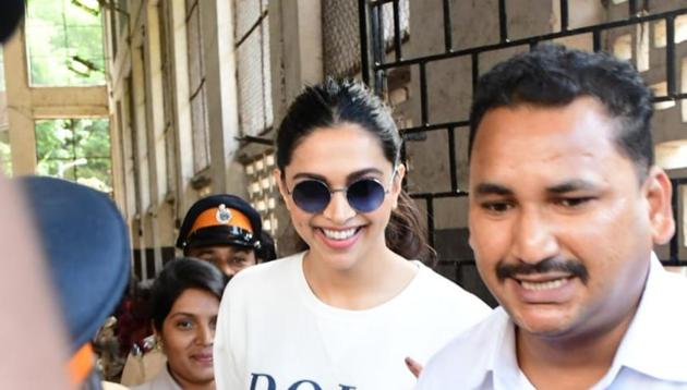 Deepika Padukone flanked by security at a polling booth. The actor cast her vote during the ongoing assembly elections. (All pics: Varinder Chawla)