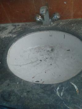 Cement strewn inside a basin in a washroom at the Thrust Theatre auditorium of the BNA in Lucknow. (Sourced) Cement strewn inside a basin in a washroom at the Thrust Theatre auditorium of the BNA in Lucknow. (Sourced)