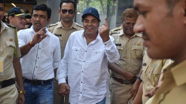 Dharmendra smiles after casting his vote.
