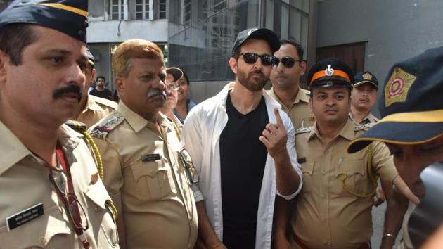 Hrithik Roshan with policemen at a polling station.