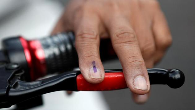 A man's inked finger is seen as he leaves a polling station on his bike after casting his vote in Mumbai. Bollywood celebrities like Aamir Khan, Preity Zinta, Hrithik Roshan, Urmila Matondkar, among others, cast their votes, urging people to exercise their franchise. (Francis Mascarenhas / REUTERS)