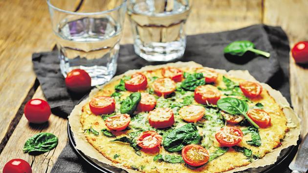Cauliflower pizza crust with tomato and spinach.(Getty Images/iStockphoto) Cauliflower pizza crust with tomato and spinach.(Getty Images/iStockphoto)