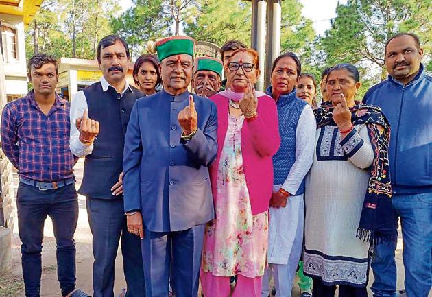 Congress candidate Gangu Ram Musafir with his family members and supporters after casting vote in the Pachhad constituency of Sirmaur district on Monday.(HT PHOTO)