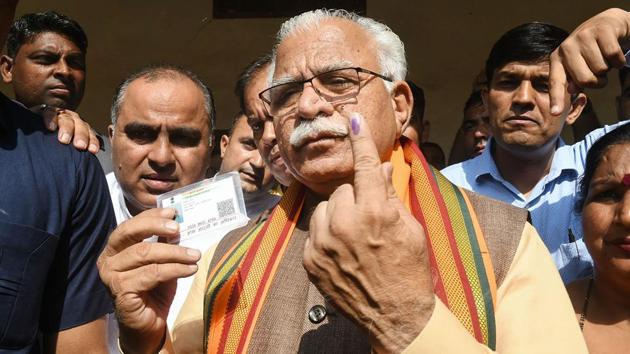 Haryana Chief Minister Manohar Lal Khattar shows his finger marked with indelible ink after casting vote in Karnal. While Khattar claimed that BJP will easily achieve its target of winning over 75 seats, Congress’ Bhupinder Singh Hooda claimed that his party will make a comeback in the state. (PTI)