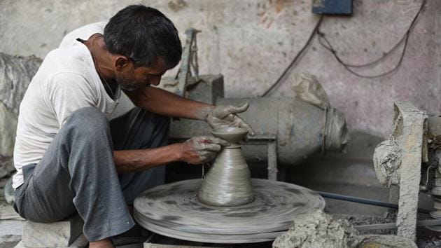 Potter Shayam Lal Prajapati, 44, at his workshop. Owing to the decreased sales over the past years, Prajapati now also cycles a rickshaw to earn a living. “These days there are few takers for our earthenware, and, with my earnings dipping like never before, I have been forced to cycle rickshaws. I make some money only during Diwali, which too has dried up this year,” he said. (Vipin Kumar / HT Photo) 