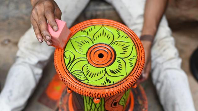 What is weighing heavily on their minds is not just lukewarm Diwali sales, but “an existential threat” facing the colony. In 2017, the colony came under National Green Tribunal’s (NGT) scanner after residents of neighbouring Bindapur village filed a case against the potters claiming that they were running industrial units in residential areas and creating pollution. (Vipin Kumar / HT Photo) 