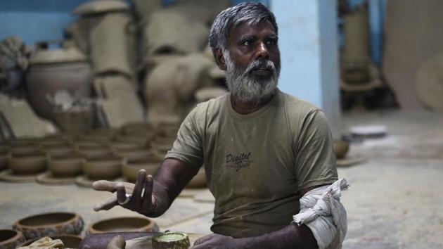 Jaikishan, another award-winning potter, at his workshop. “There was a time I was invited every year by Gandhi Darshan to show visitors how a potter’s wheel works. I think the time is not far when our colony will become a museum of a lost art,” he said. (Vipin Kumar / HT Photo) 