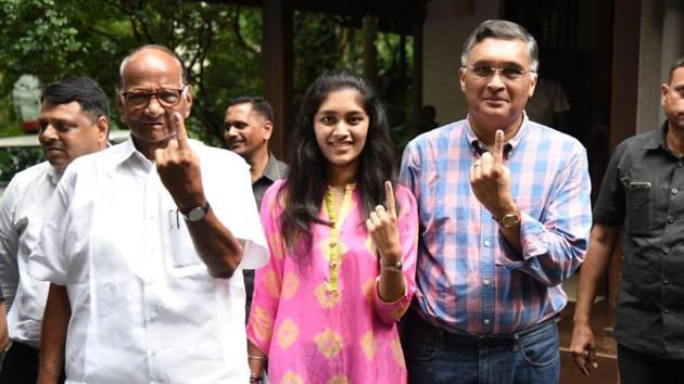 Nationalist Congress Party (NCP) chief Sharad Pawar, his son-in-law Sadanand Sule and granddaughter Revati Sule pose after casting their vote. Pawar appealed to the people to come out in large numbers and exercise their franchise. (Bhushan Koyande / HT Photo)